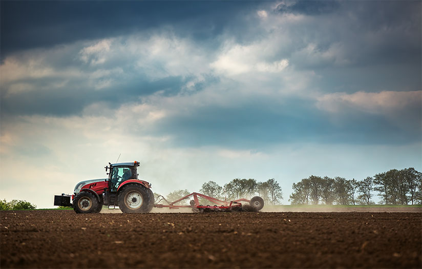 Tractor plowing in field